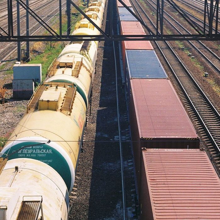 Aerial view of a cargo train on railway tracks during the day.
